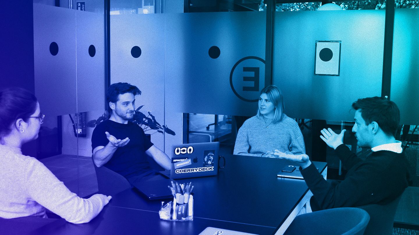 A group of people discussing in an office space