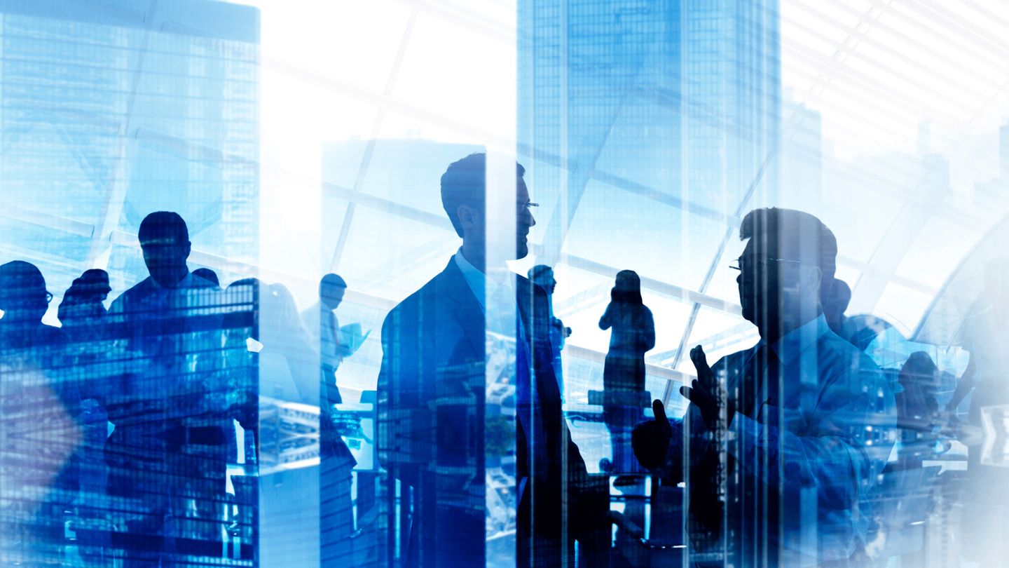 An abstract double-exposure photograph presenting skyscrapers and people